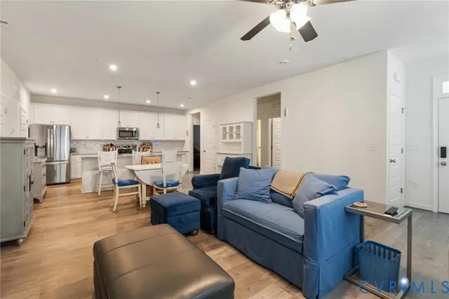 a living room with furniture and kitchen view