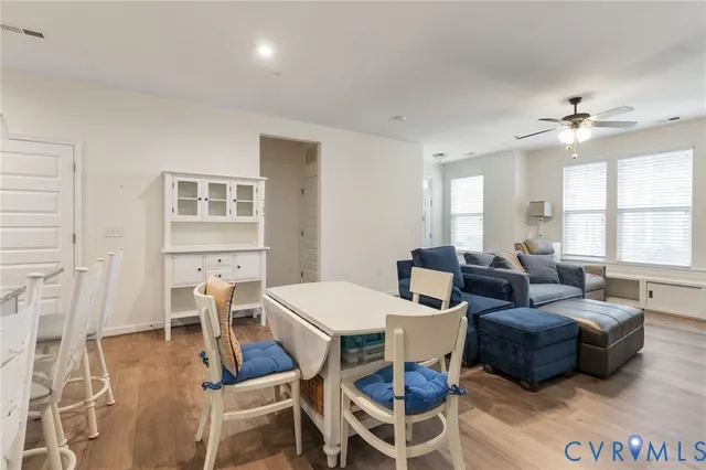 a living room with furniture a chandelier and a window