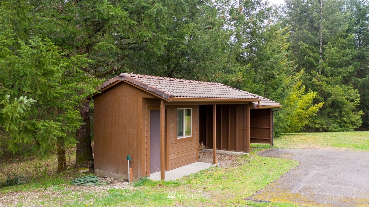 7425 Bordeaux Road Southwest Olympia, WA 98512 - Photo 22 of 25 a view of small house with yard and trees in the background