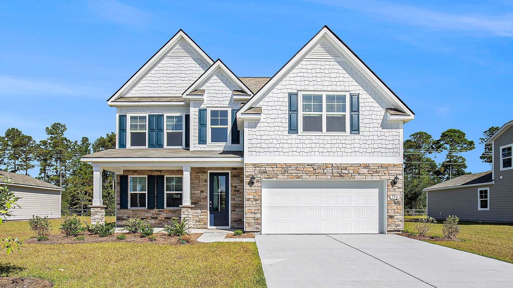 Craftsman-style house featuring a front lawn, covered porch, stone siding, an attached garage, and concrete driveway
