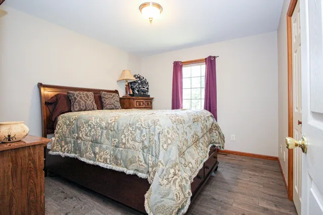 a bed sitting in a bedroom next to a window