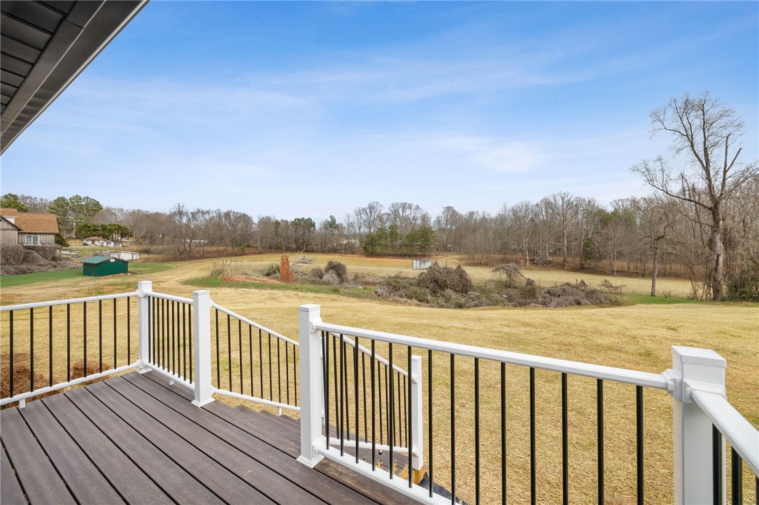 139 Davis Road Easley, SC 29640 - Photo 7 of 34 Step out onto the spacious deck and embrace the expansive, verdant surroundings.