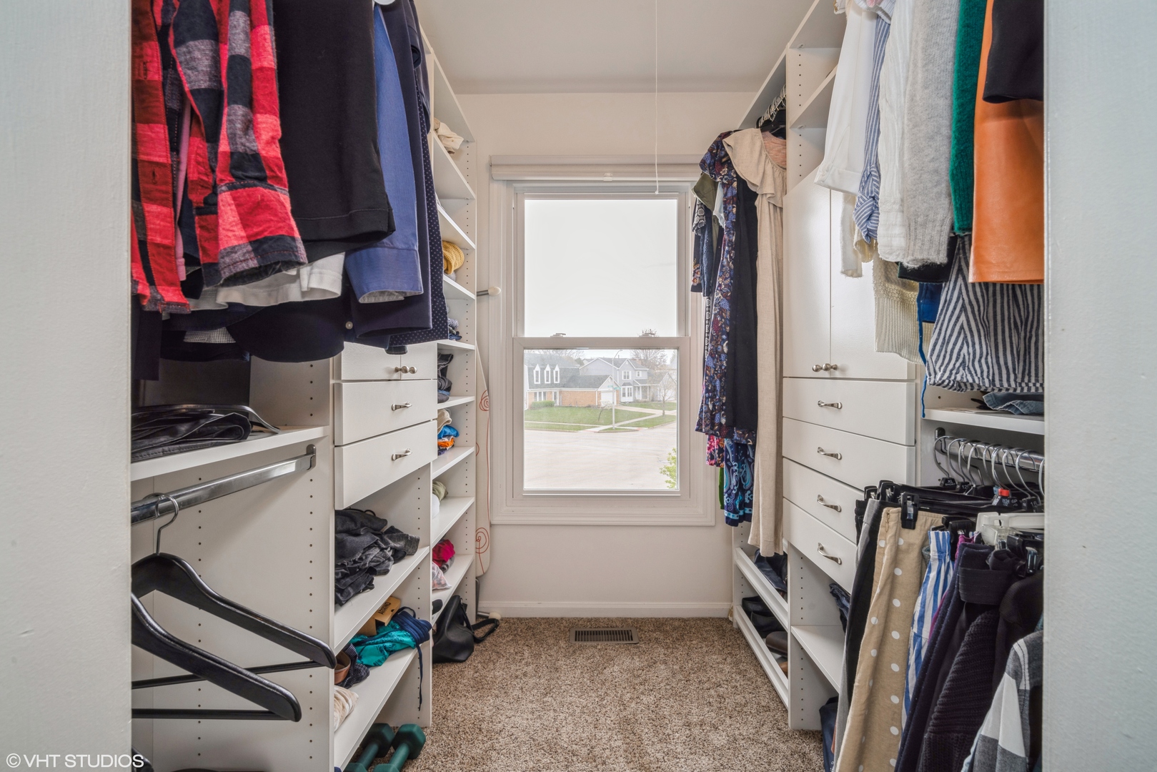 1145 John Drive Hoffman Estates, IL 60169 - Photo 28 of 36 a view of walk in closet with clothes and shoes