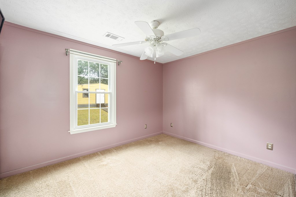 2103 Terrace Drive Columbus, GA 31904 - Photo 10 of 15 an empty room with a ceiling fan and a window