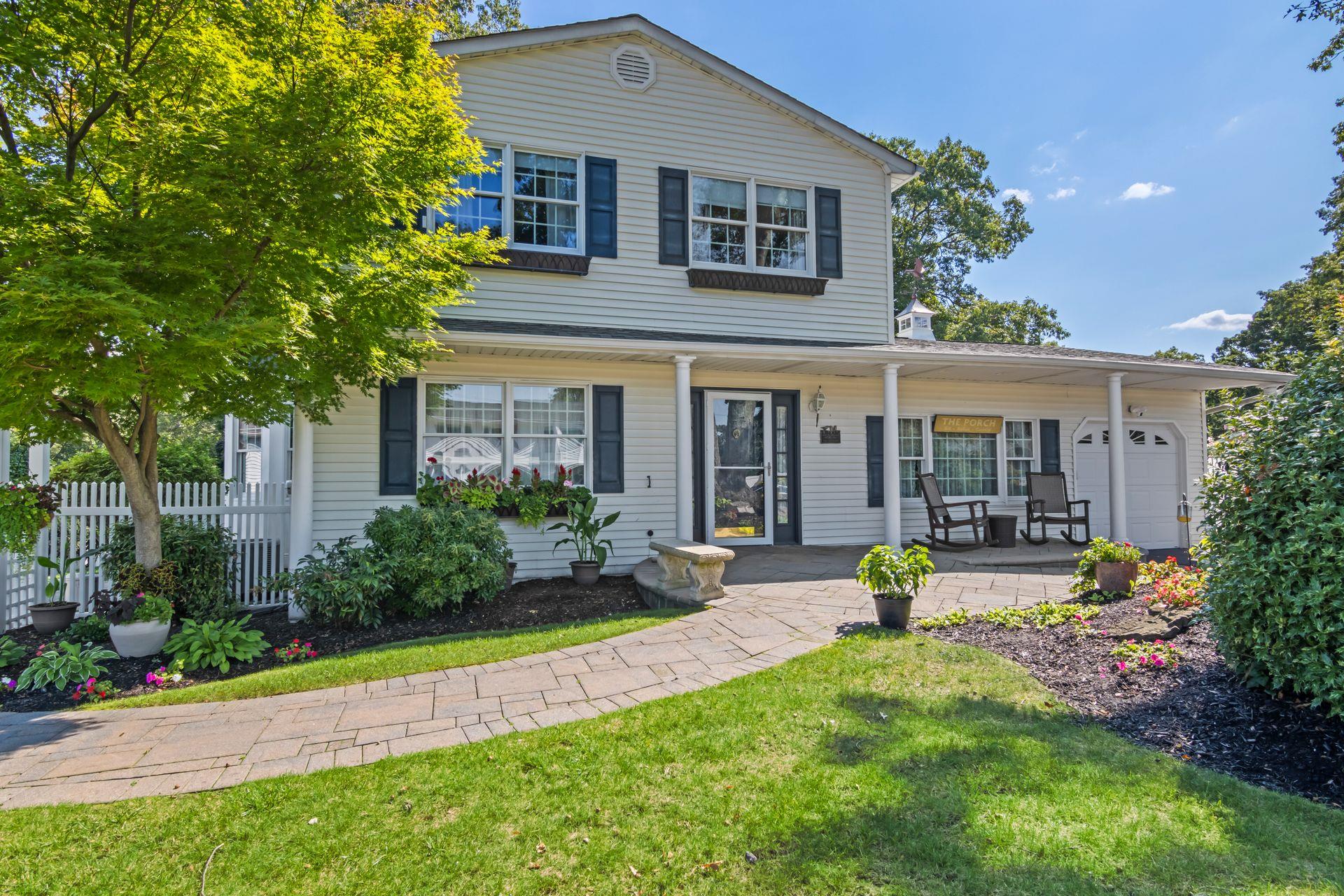 81 Brunswick Road Ronkonkoma, NY 11779 - Photo 1 of 1 Traditional-style house with covered porch and an attached garage