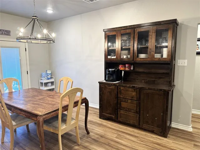 a dining room with furniture and wooden floor