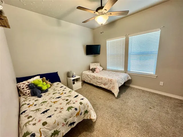 a bedroom with double bed and a window