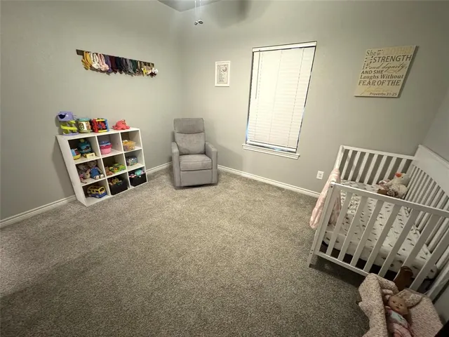 a bedroom with furniture and a book shelf