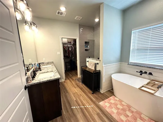 a bathroom with a sink double vanity and a mirror