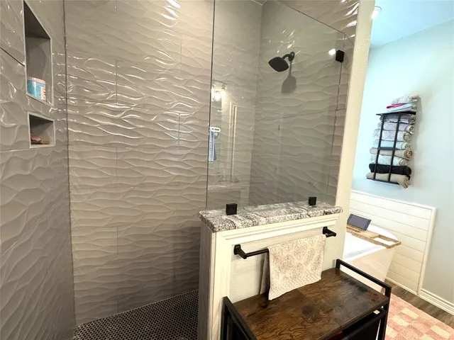 a bathroom with a sink a toilet a shower and mirror