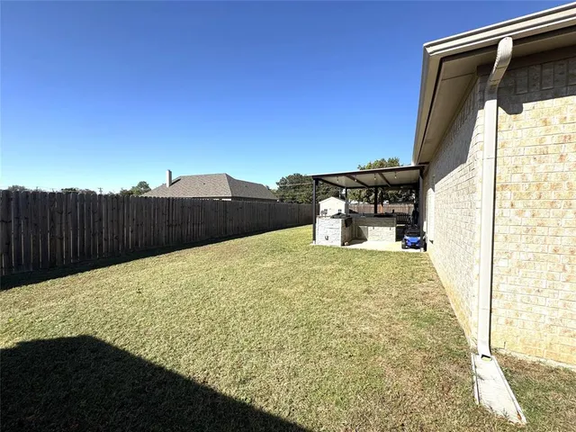 a dining room with furniture and a floor to ceiling window