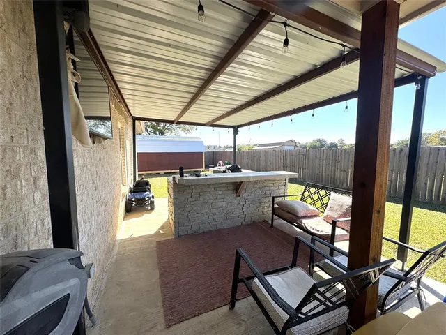 a view of a backyard with sitting area