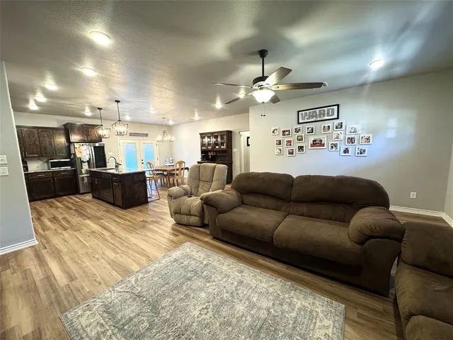 a view of a living room kitchen and a wooden floor