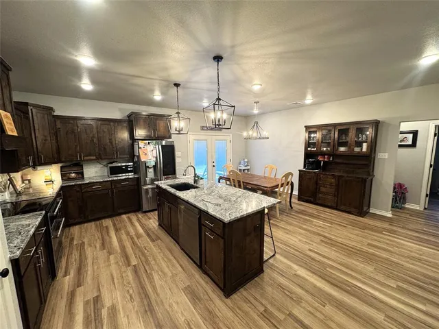 a kitchen with stainless steel appliances granite countertop a stove oven and a refrigerator