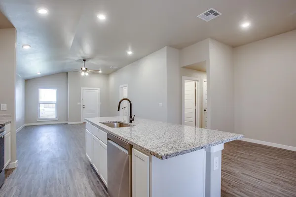 a view of an empty room with wooden floor and closet