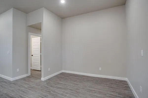 an empty room with closet and fan