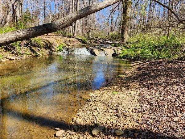 a view of water with a yard