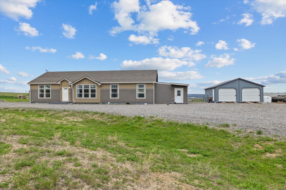 3992 Vista View Road Billings, MT 59101 - Photo 1 of 1 Ranch-style house featuring a garage, board and batten siding, and an outbuilding