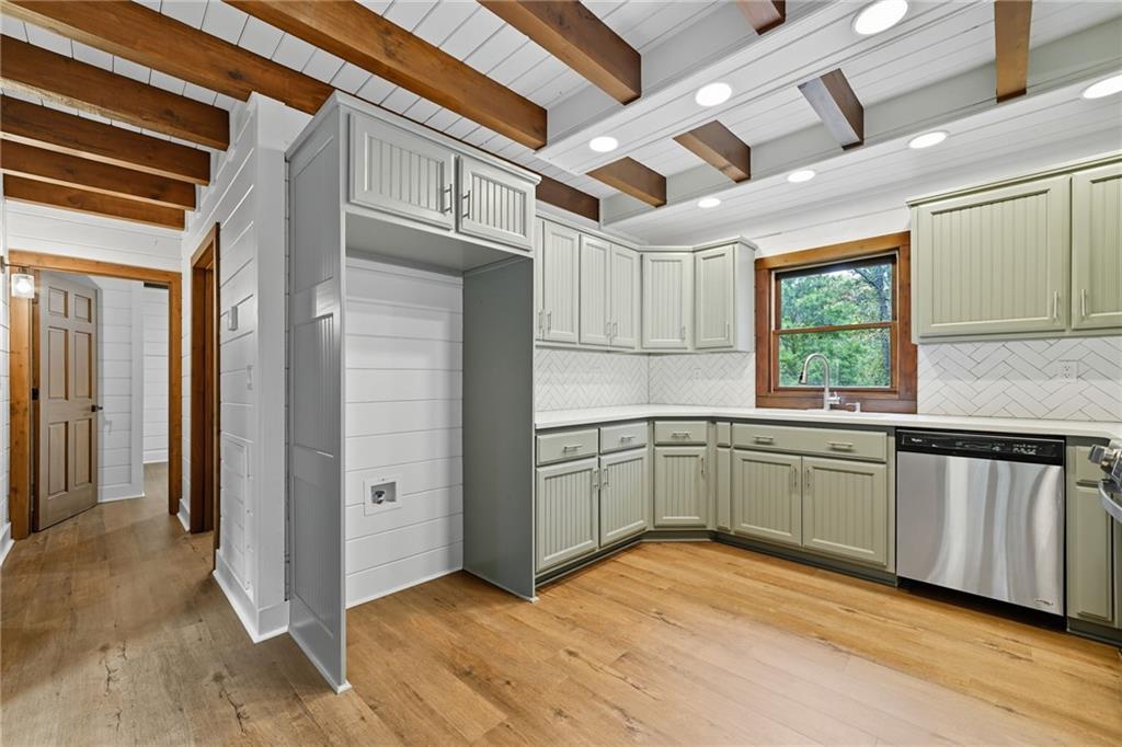 509 East Valley Road Northeast Rydal, GA 30171 - Photo 11 of 27 a kitchen with granite countertop a sink cabinets stainless steel appliances and a window