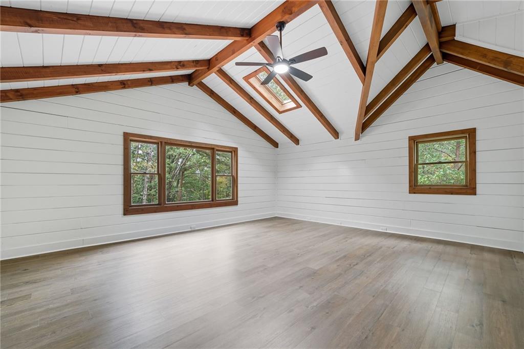 509 East Valley Road Northeast Rydal, GA 30171 - Photo 18 of 27 an empty room with wooden floor and windows
