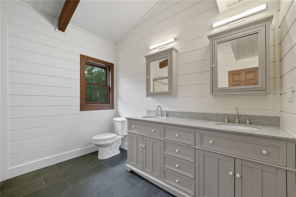 509 East Valley Road Northeast Rydal, GA 30171 - Photo 21 of 27 a bathroom with a toilet sink and mirror