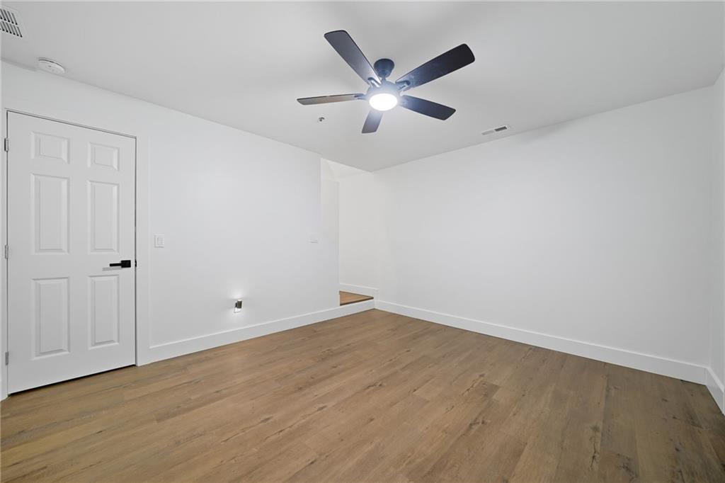 509 East Valley Road Northeast Rydal, GA 30171 - Photo 23 of 27 an empty room with wooden floor and windows