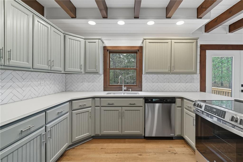 509 East Valley Road Northeast Rydal, GA 30171 - Photo 10 of 27 a kitchen with a sink stove and cabinets