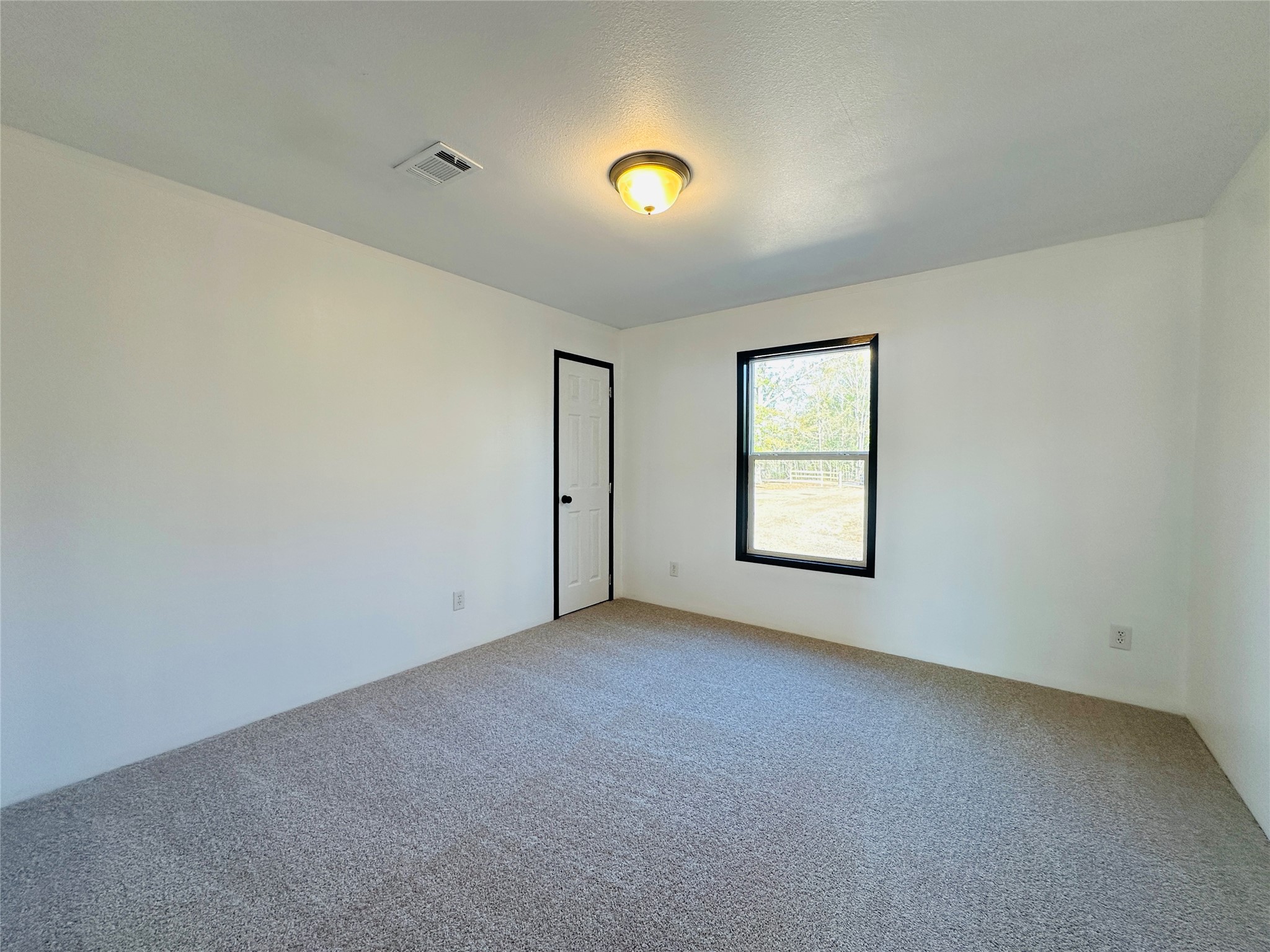 145 Campbell Street Shepherd, TX 77371 - Photo 14 of 36 a view of an empty room with a window