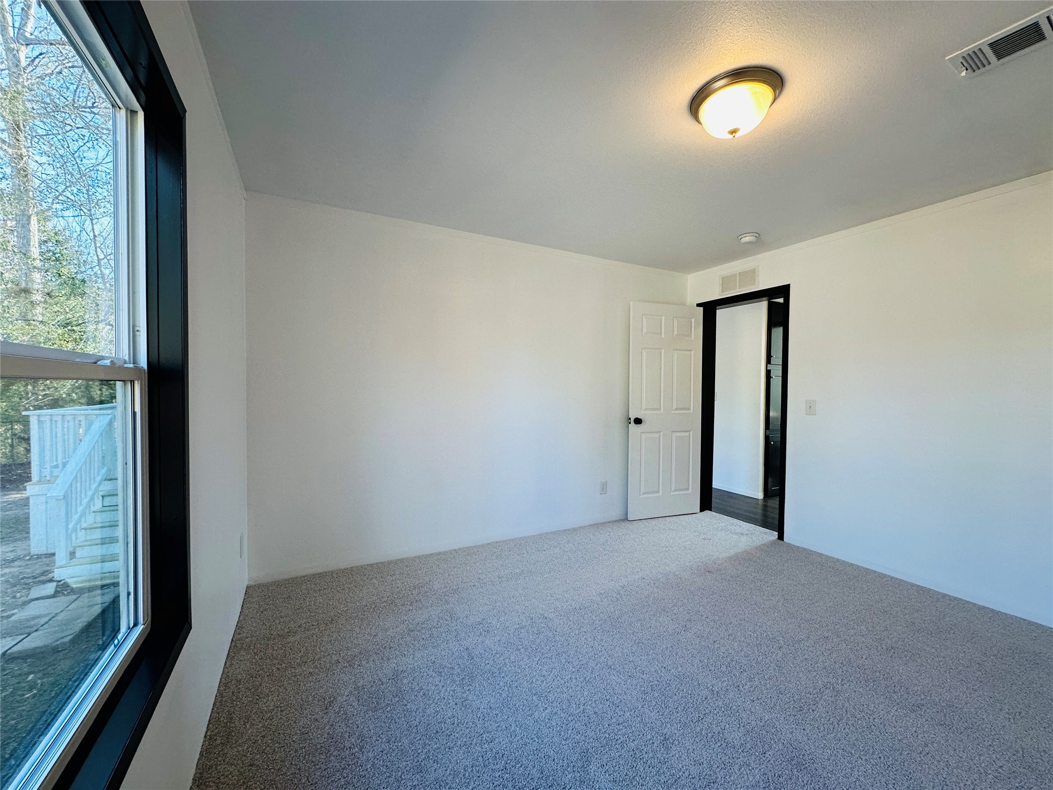 145 Campbell Street Shepherd, TX 77371 - Photo 16 of 36 an empty room with windows and entrance