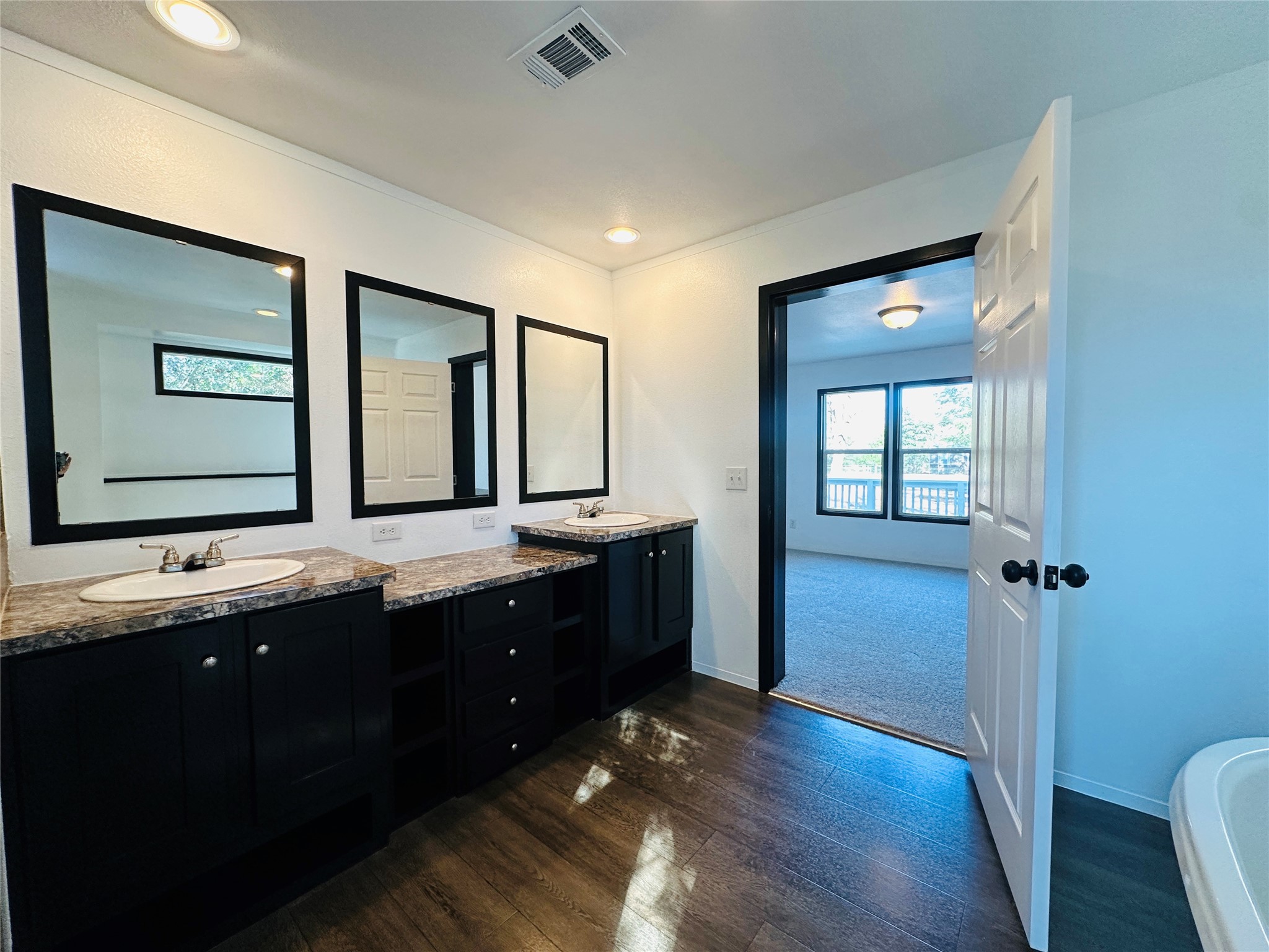 145 Campbell Street Shepherd, TX 77371 - Photo 23 of 36 a bathroom with a double vanity sink and mirror