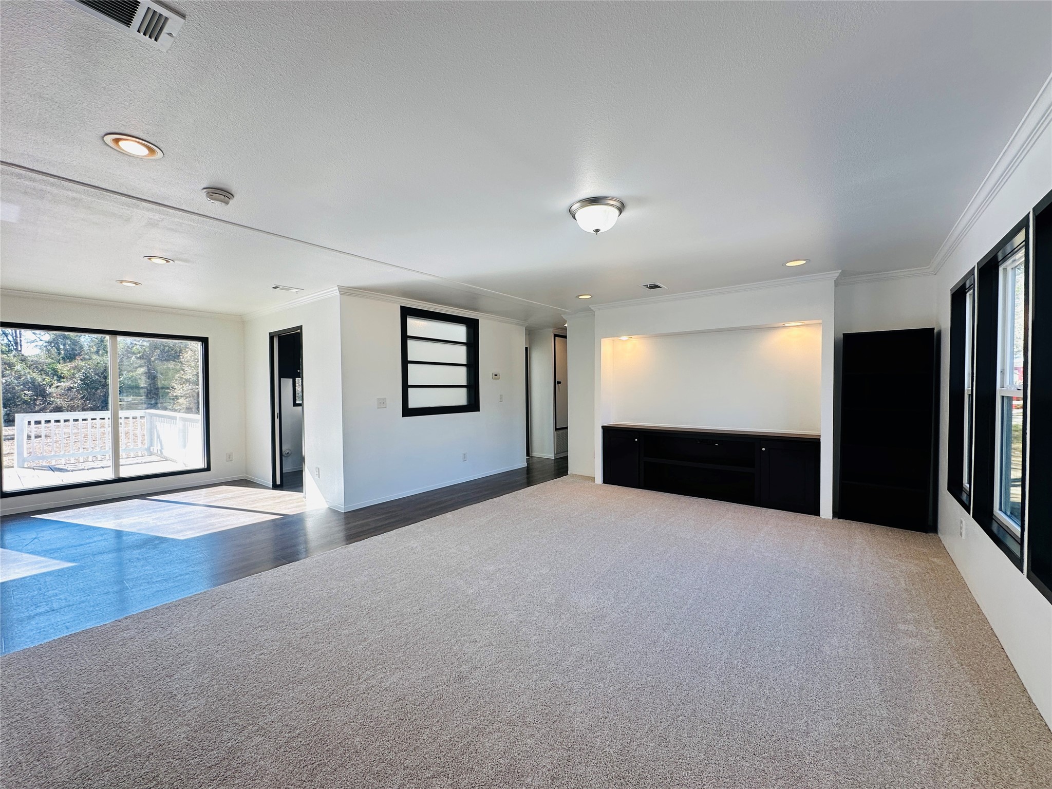 145 Campbell Street Shepherd, TX 77371 - Photo 3 of 36 a view of an empty room with a window and wooden floor