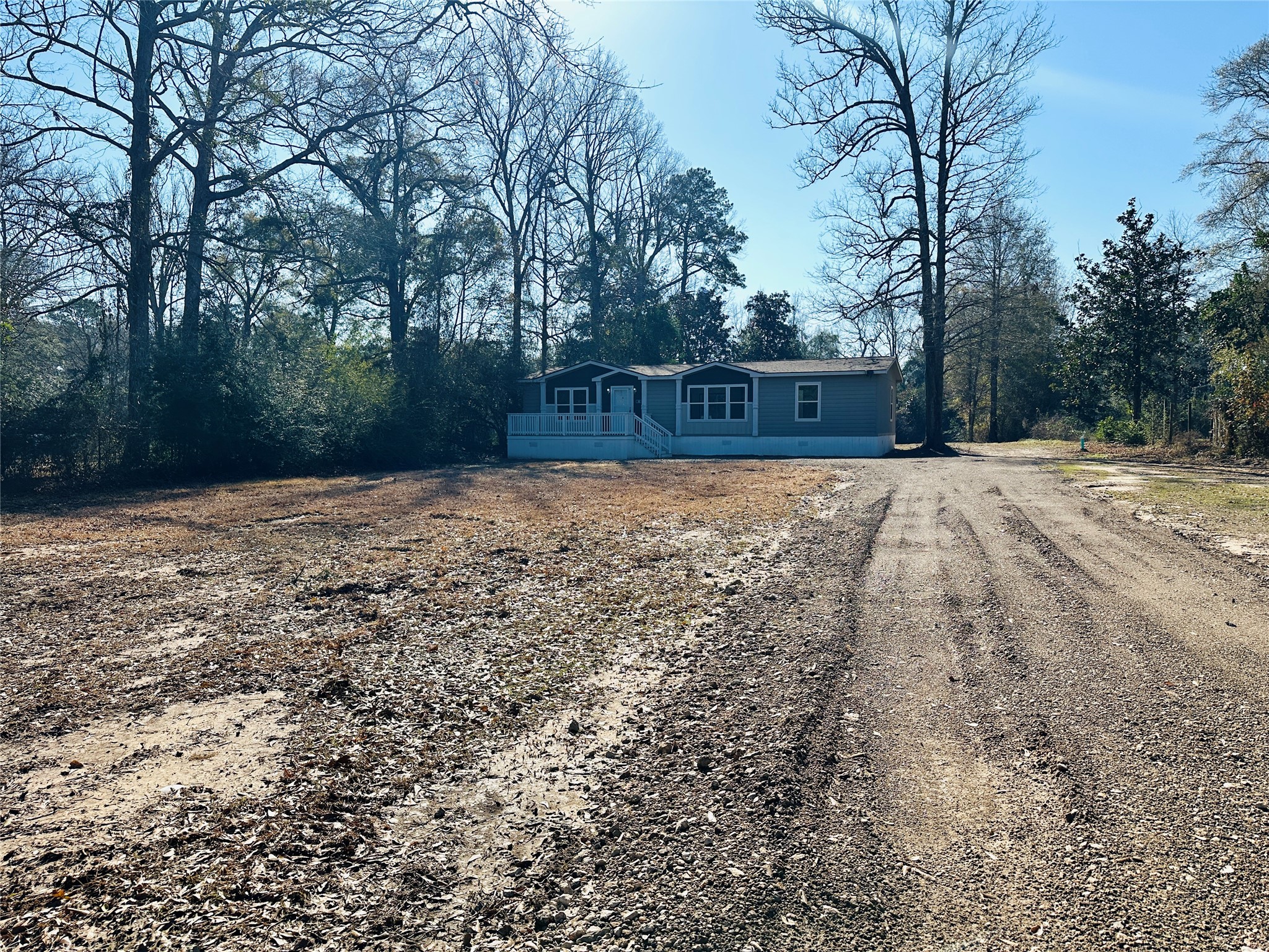 145 Campbell Street Shepherd, TX 77371 - Photo 33 of 36 a backyard of a house with lots of green space
