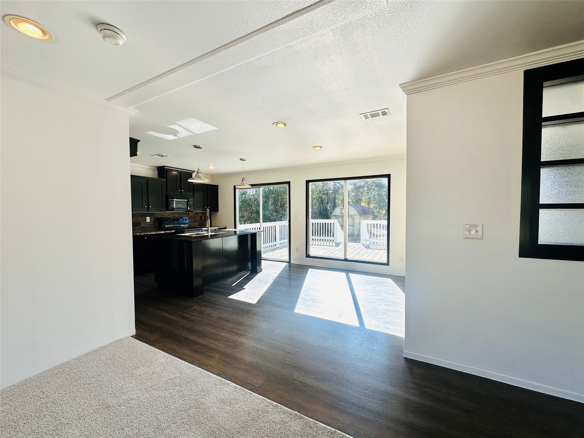 145 Campbell Street Shepherd, TX 77371 - Photo 5 of 36 a view of a kitchen with a sink and dishwasher a refrigerator with wooden floor