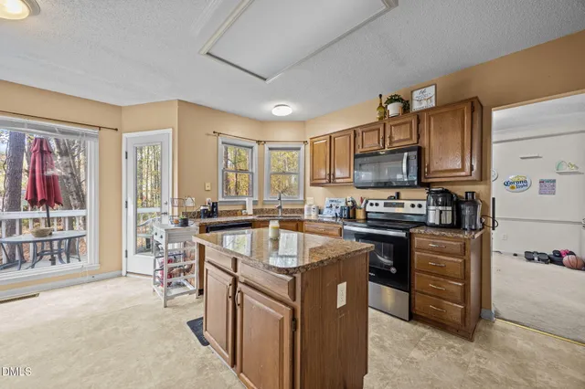 a living room with furniture and large windows