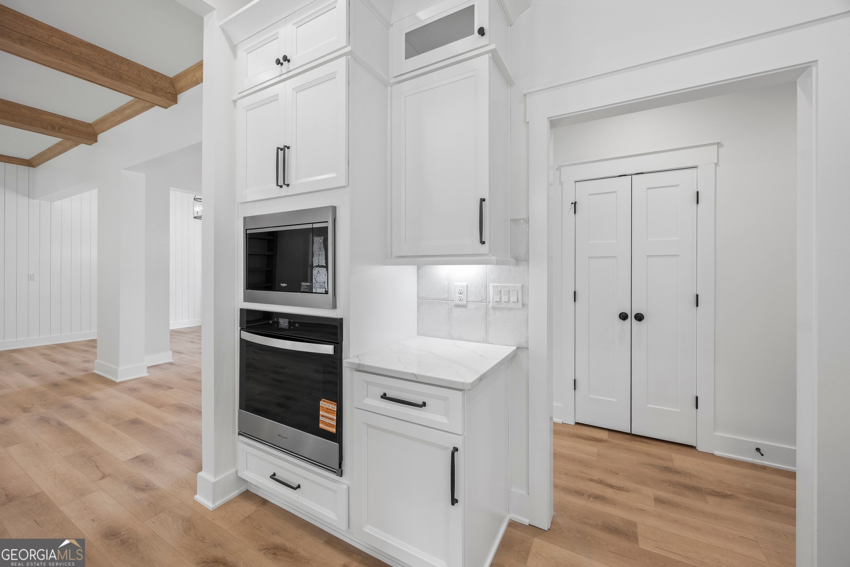 1231 John W Breedlove Road Monroe, GA 30656 - Photo 15 of 26 a kitchen with white cabinets and white appliances