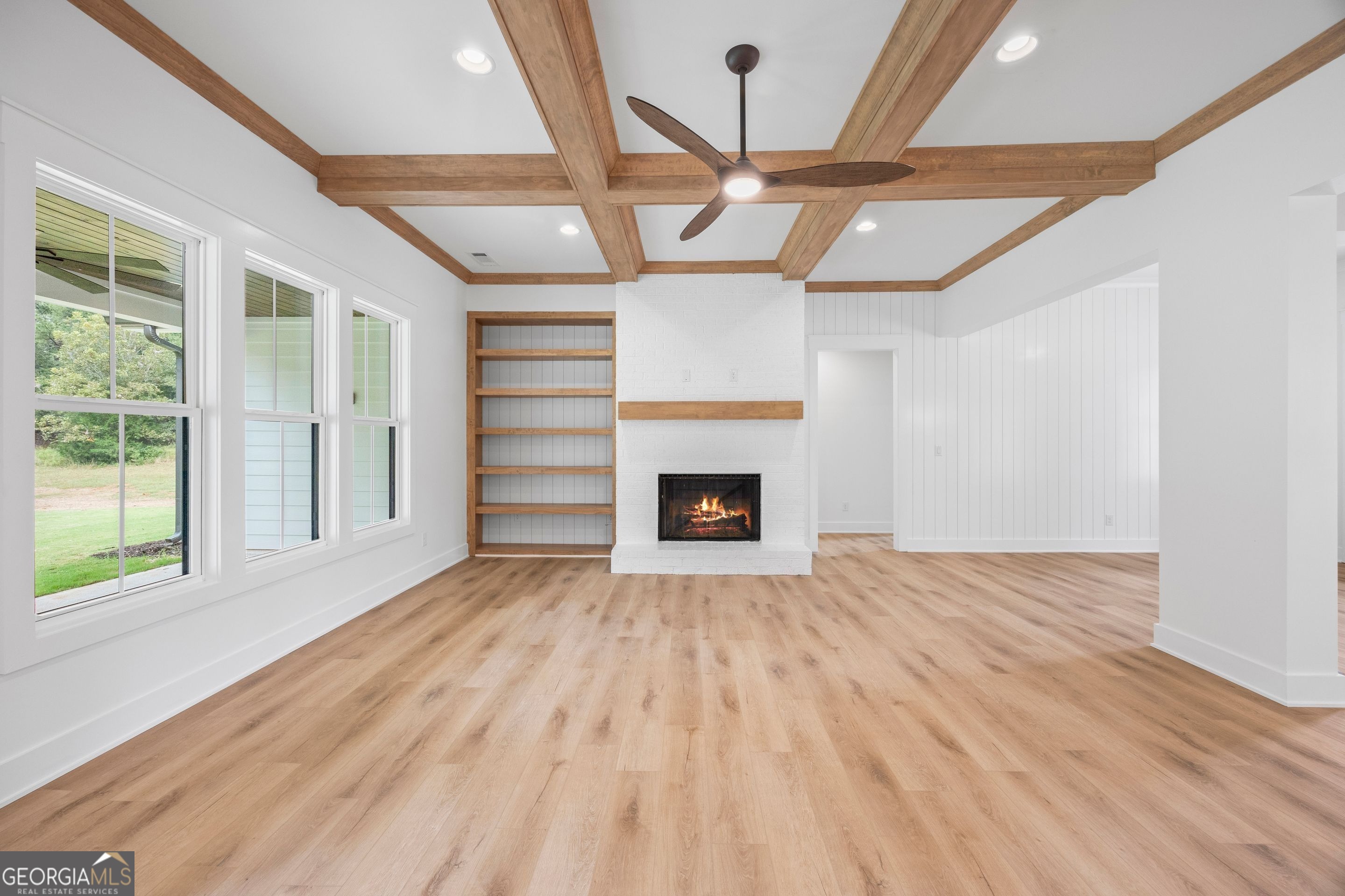1231 John W Breedlove Road Monroe, GA 30656 - Photo 5 of 26 a view of an empty room with a fireplace and a window