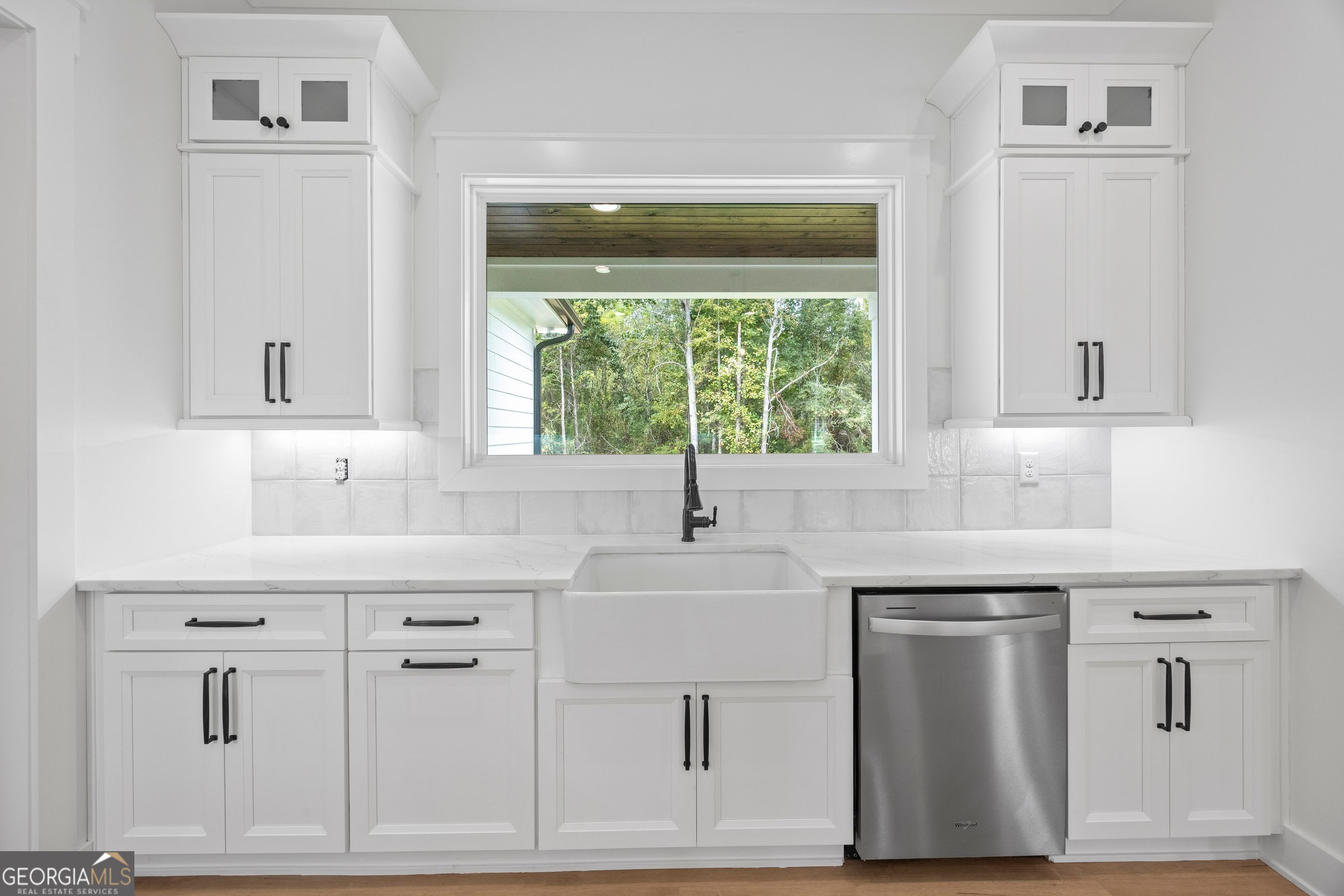 1231 John W Breedlove Road Monroe, GA 30656 - Photo 8 of 26 a kitchen with white cabinets and a window
