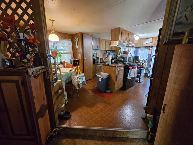 a view of a living room with furniture and a kitchen