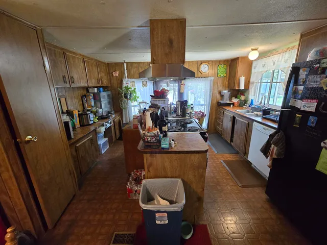 a kitchen with a sink appliances and cabinets