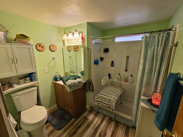 a bathroom with a sink toilet and shower