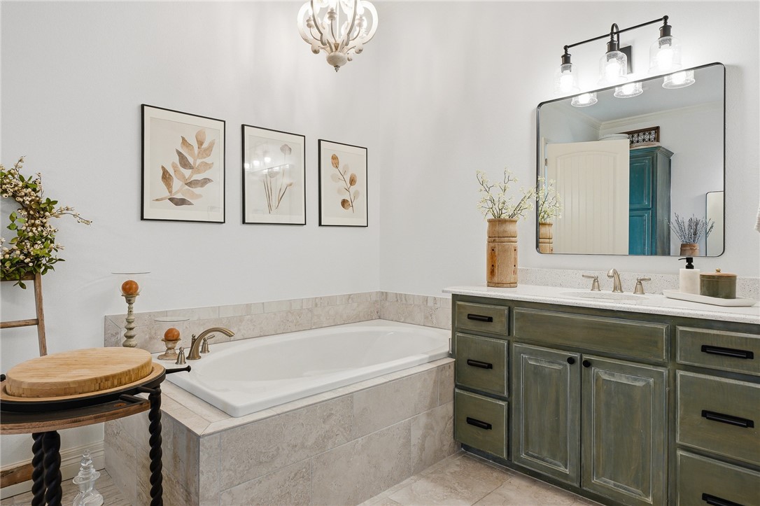8710 KIng Ranch Drive Corpus Christi, TX 78414 - Photo 20 of 38 a bathroom with a tub sink and mirror