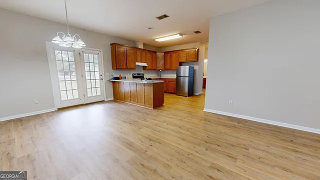 a view of a kitchen with microwave and furniture