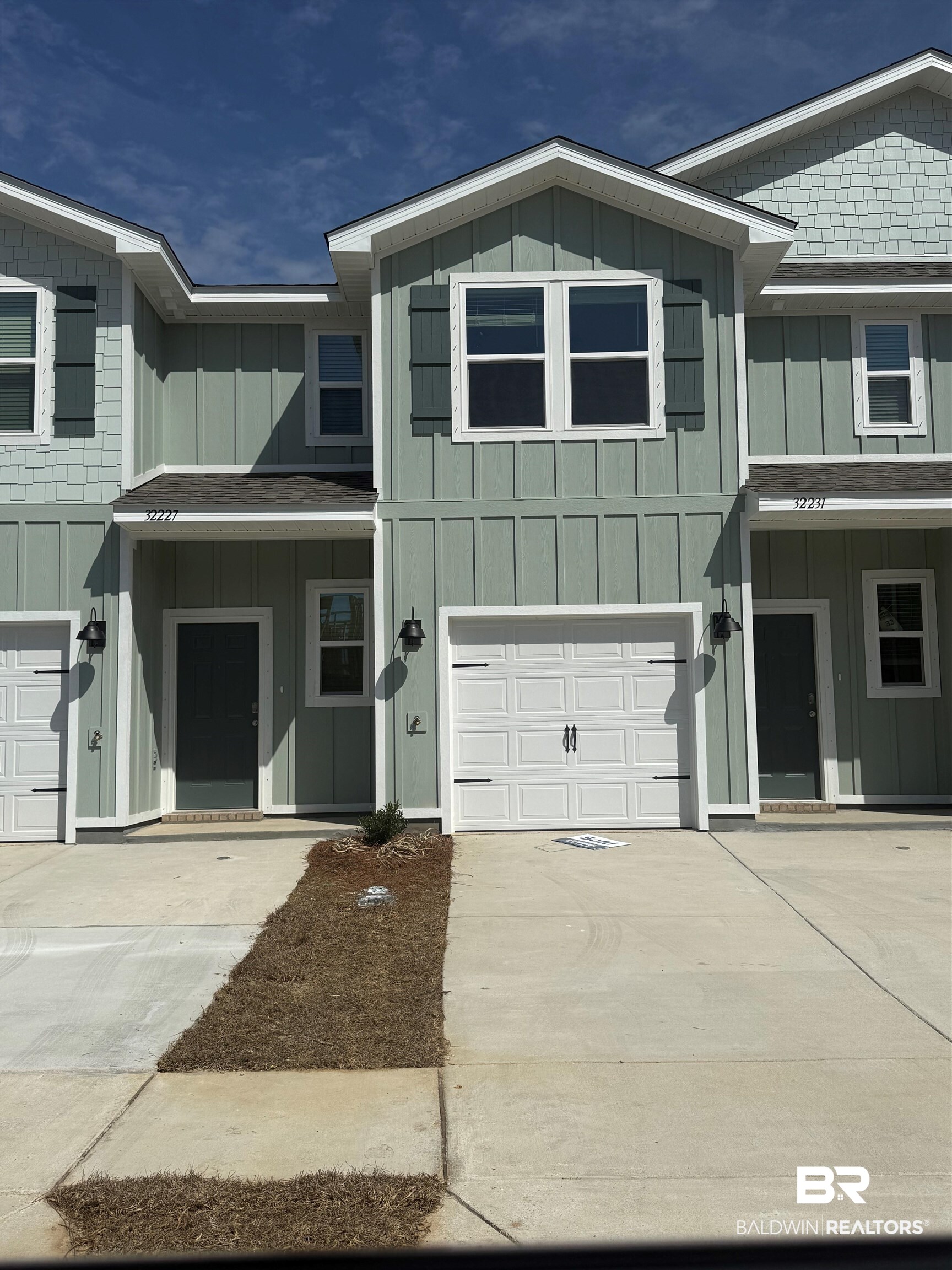 32235 Emancipation Circle Daphne, AL 36527 - Photo 1 of 42 View of front facade with an attached garage, a porch, board and batten siding, and concrete driveway
