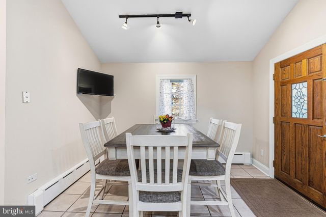 a view of a room with wooden floor and white walls