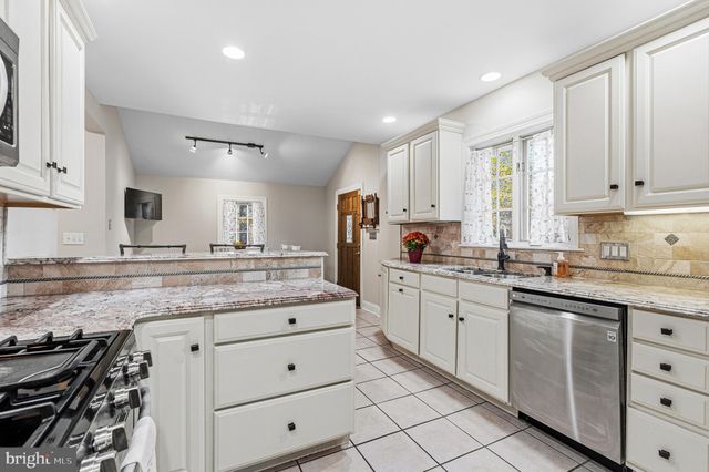 a living room with furniture a fireplace and flat screen tv