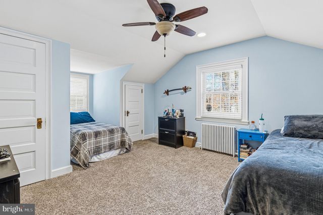 an aerial view of house with yard and mountain view in back