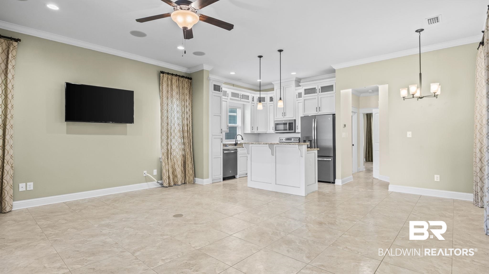 12361 Reunion Place Foley, AL 36535 - Photo 10 of 43 Kitchen featuring a center island, glass insert cabinets, decorative light fixtures, ornamental molding, and white cabinets