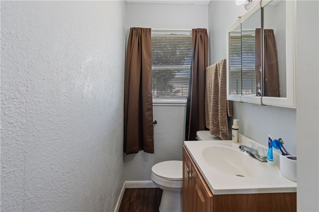 4846 Kasper Street Corpus Christi, TX 78415 - Photo 12 of 20 a bathroom with a sink toilet and shower