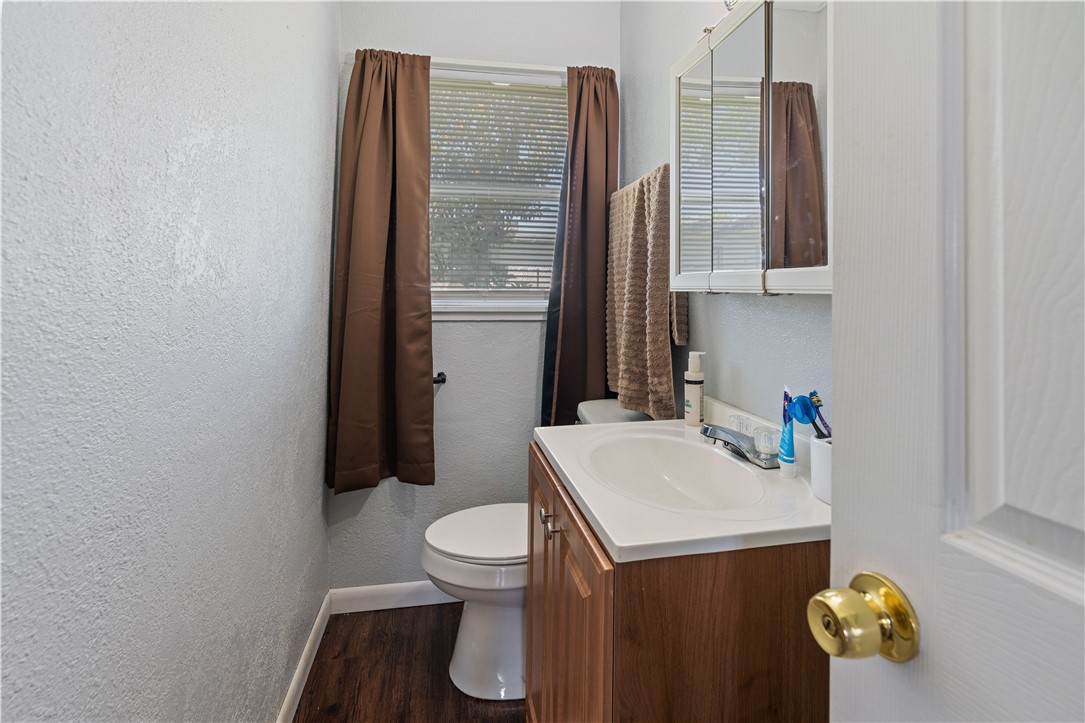 4846 Kasper Street Corpus Christi, TX 78415 - Photo 13 of 20 a bathroom with a toilet sink and mirror