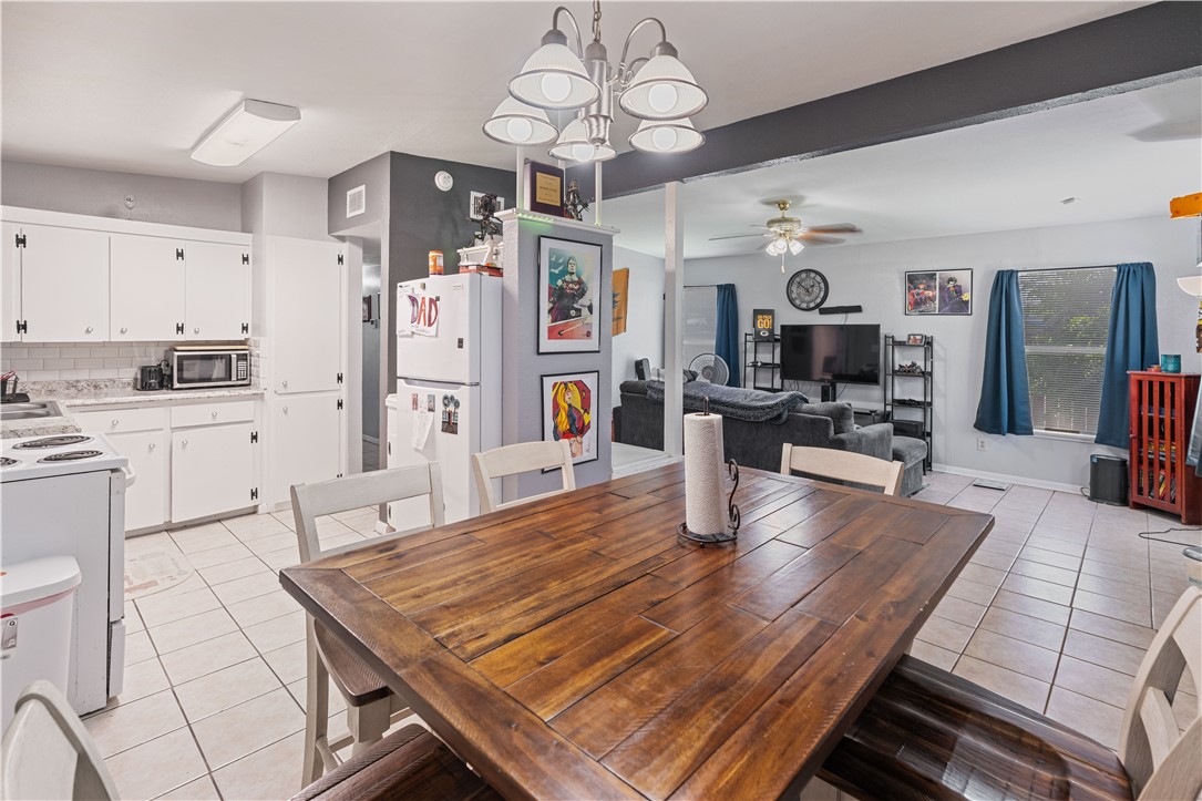 4846 Kasper Street Corpus Christi, TX 78415 - Photo 6 of 20 a living room with stainless steel appliances kitchen island granite countertop furniture and a kitchen view